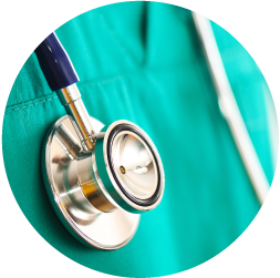 Close-up of a stethoscope on a healthcare worker's teal uniform.