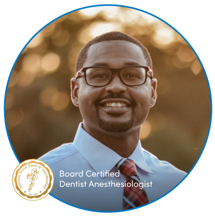 Professional portrait of a smiling man with glasses and bow tie.